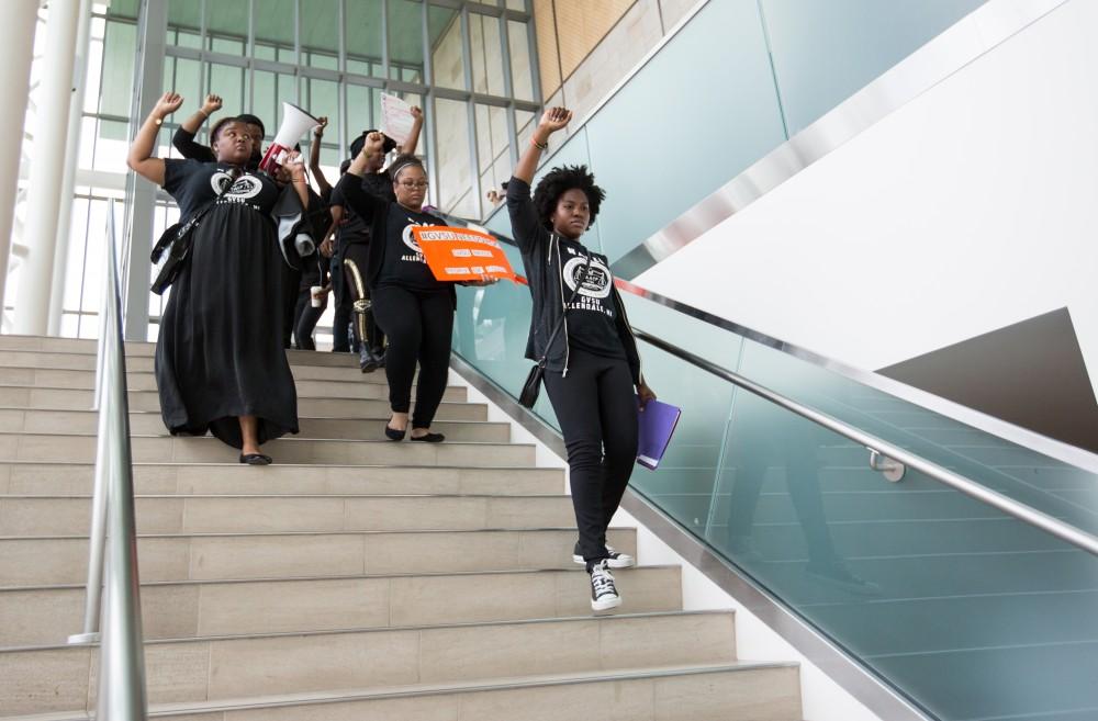 GVL/Kevin Sielaff - Cheyanna Green-Molett leads students through the Mary Idema Pew Library during the demonstration. Grand Valley's NAACP chapter holds a campus wide demonstration in protest of police brutality Friday, Sept. 23, 2016 in Allendale.