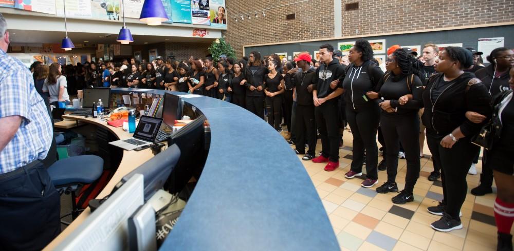 GVL/Kevin Sielaff - Demonstrators gather within the Kirkhof Center for ten minutes of silence. Grand Valley's NAACP chapter holds a campus wide demonstration in protest of police brutality Friday, Sept. 23, 2016 in Allendale.