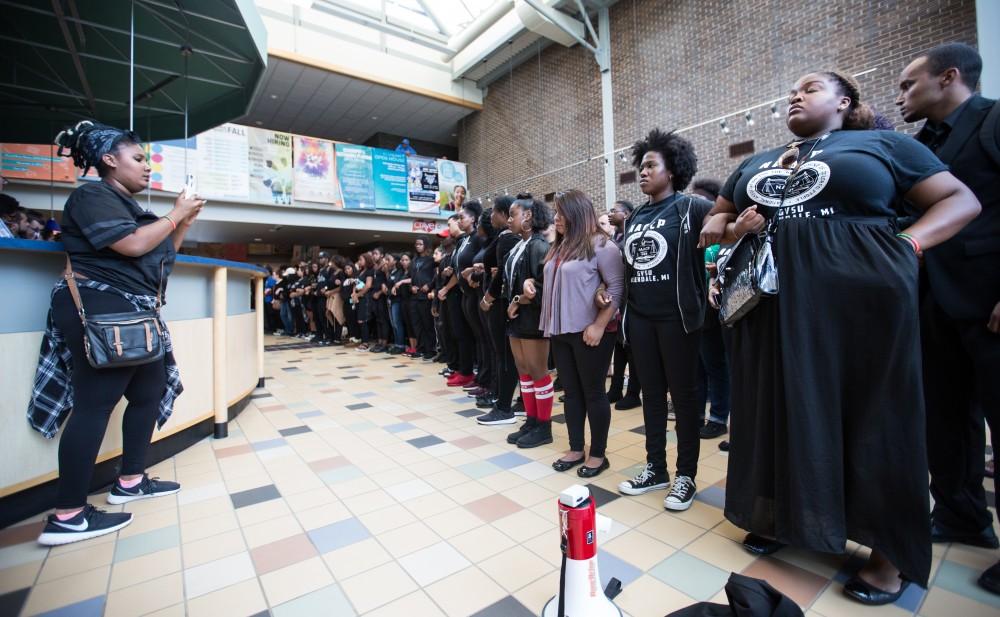 GVL/Kevin Sielaff - Demonstrators gather within the Kirkhof Center for ten minutes of silence. Grand Valley's NAACP chapter holds a campus wide demonstration in protest of police brutality Friday, Sept. 23, 2016 in Allendale.