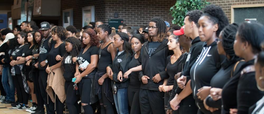 GVL/Kevin Sielaff - Demonstrators gather within the Kirkhof Center for ten minutes of silence. Grand Valley's NAACP chapter holds a campus wide demonstration in protest of police brutality Friday, Sept. 23, 2016 in Allendale.