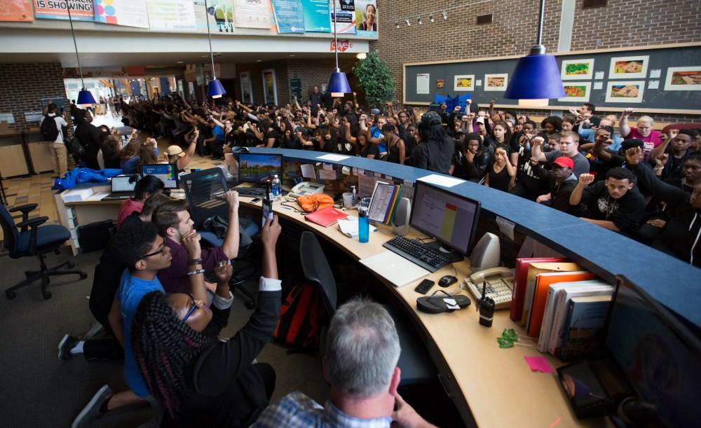 GVL/Kevin Sielaff - Demonstrators gather within the Kirkhof Center for ten minutes of silence. Grand Valley's NAACP chapter holds a campus wide demonstration in protest of police brutality Friday, Sept. 23, 2016 in Allendale.