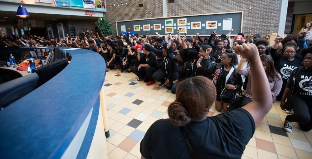 GVL/Kevin Sielaff - Demonstrators gather within the Kirkhof Center for ten minutes of silence. Grand Valley's NAACP chapter holds a campus wide demonstration in protest of police brutality Friday, Sept. 23, 2016 in Allendale.