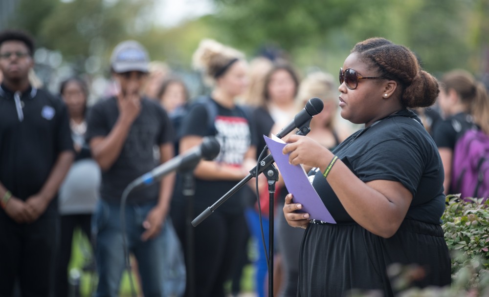 GVL/Kevin Sielaff - Antoinette Jackson speaks to the crowd surrounding the clock tower. Grand Valley's NAACP chapter holds a campus wide demonstration in protest of police brutality Friday, Sept. 23, 2016 in Allendale.