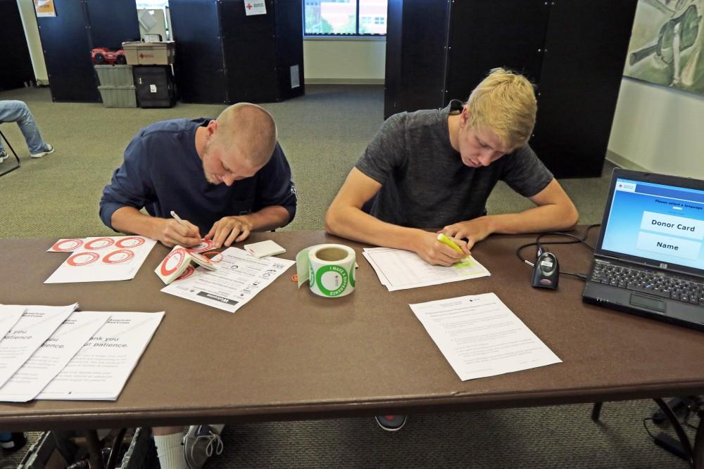 GVL / Emily Frye  
Students Tristan Flowers (left) and Caleb Mitchell (right) volunteer during the blood drive on Tuesday Sept. 20, 2016.