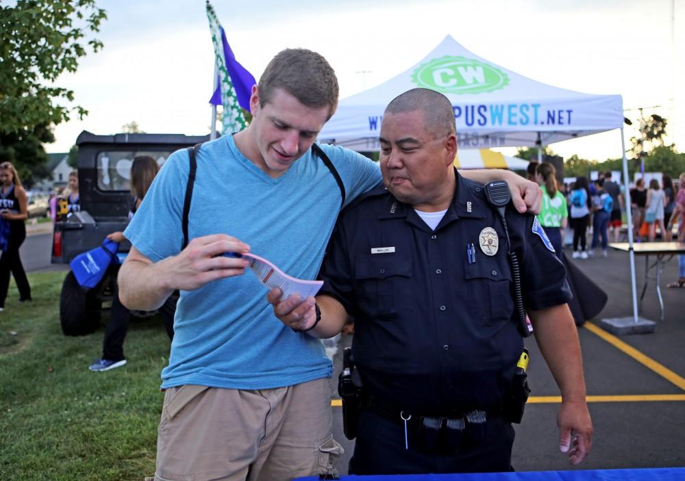 GVL / Emily Frye
Officer Minh Lien talks to a student about the Grand Valley Police Department during Campus Life Night on Tuesday Sept. 6th, 2016. 