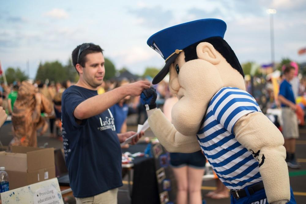 GVL / Luke Holmes - Louie the Laker bumps fists with a student during Campus Life Night. Campus Night Life was held in the Parking Lot H on Tuesday, Sep. 6, 2016.