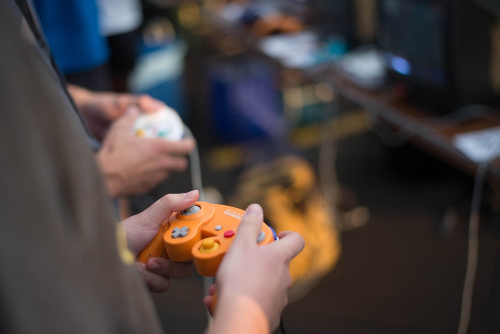 GVL / Luke Holmes - Students play "Super Smash Bros. Melee" at the Smash Bros Club table. Campus Night Life was held in the Parking Lot H on Tuesday, Sep. 6, 2016.