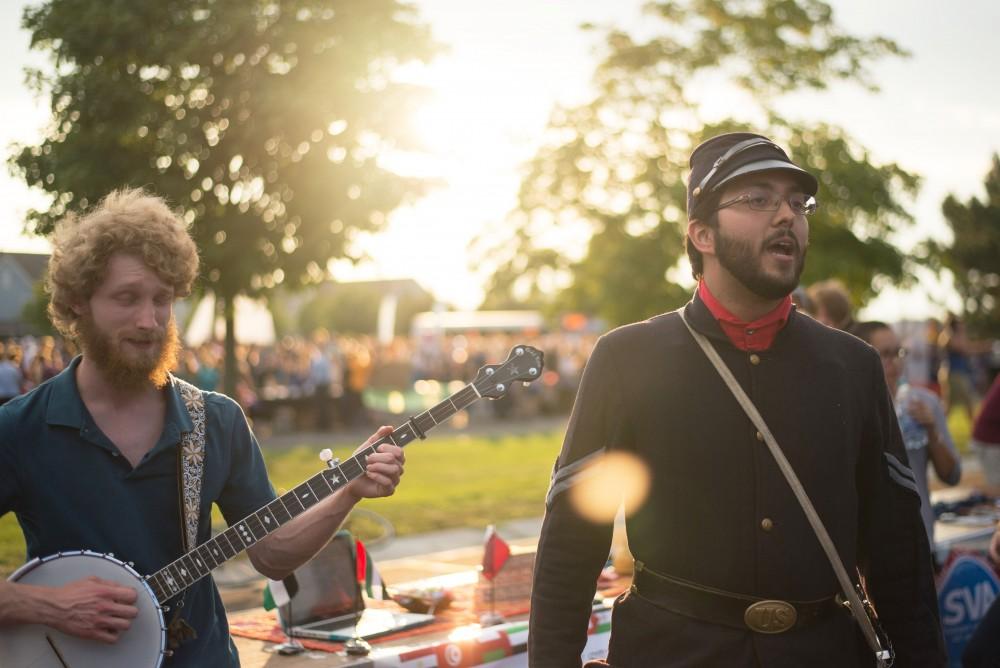 GVL / Luke Holmes - Devin O'Connor plays banjo while Llama Gomes sings during the Campus Life Night. Campus Night Life was held in the Parking Lot H on Tuesday, Sep. 6, 2016.