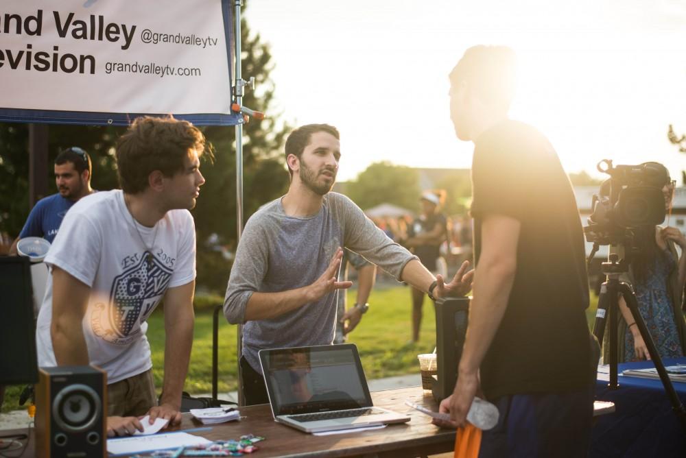 GVL / Luke Holmes - Joey Parks talks to a student about Grand Valley Television. Campus Night Life was held in the Parking Lot H on Tuesday, Sep. 6, 2016.