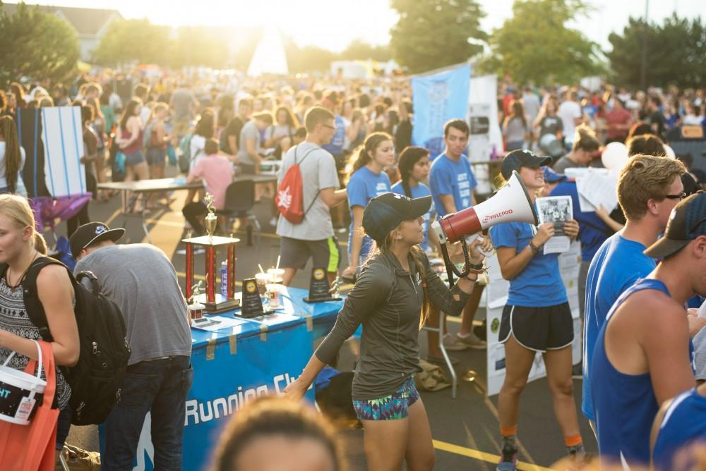 GVL / Luke Holmes - Sarah Waraniak uses a megaphone to promote the Running Club. Campus Night Life was held in the Parking Lot H on Tuesday, Sep. 6, 2016.