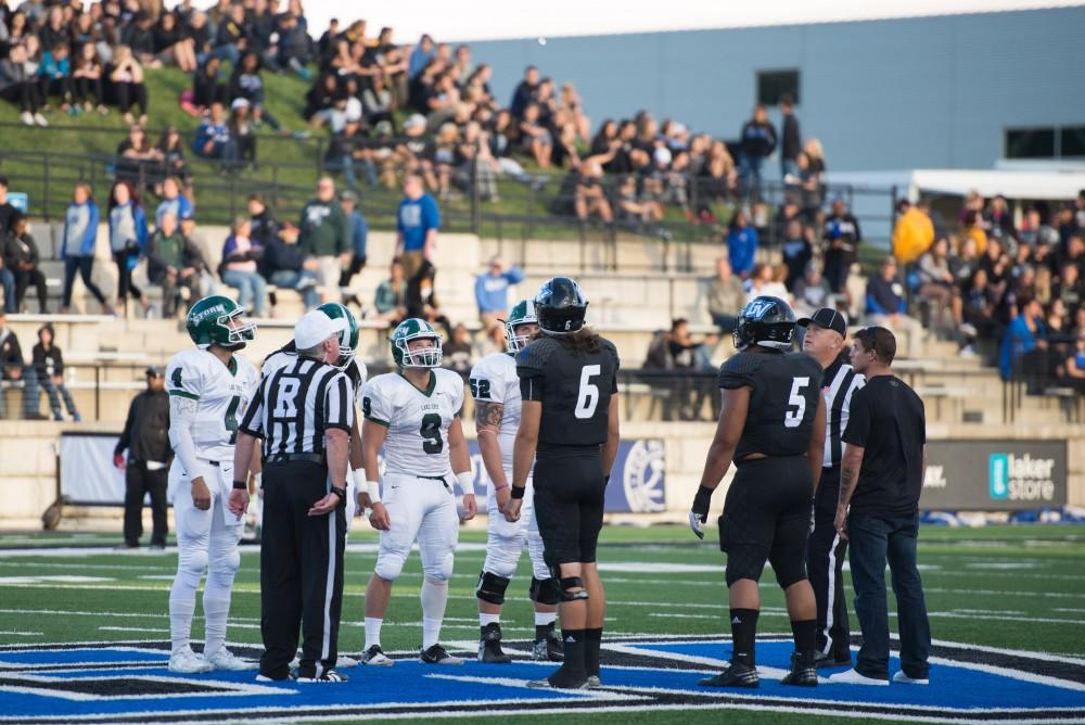 GVL / Luke Holmes - The team celebrates after Marty Carter (21) scores a touchdown. GVSU defeated Northern Michigan University 50-24 in Lubber's Stadium on Saturday, Sept. 17, 2016.