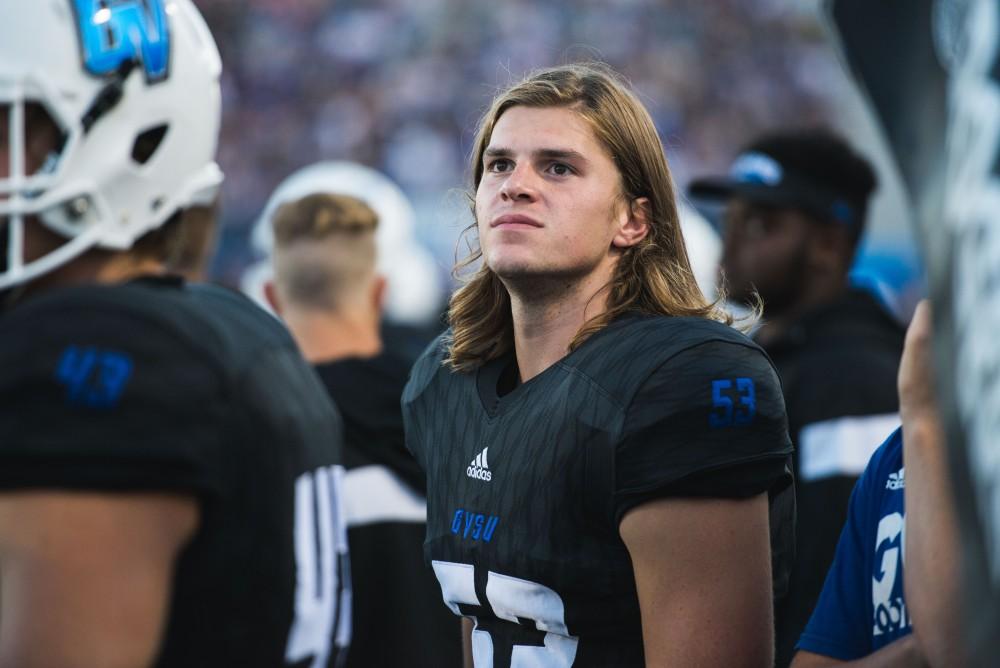 GVL / Luke Holmes - J.J. McGrath (53) glances at the scoreboard. GVSU defeated Northern Michigan University 50-24 in Lubber's Stadium on Saturday, Sept. 17, 2016.