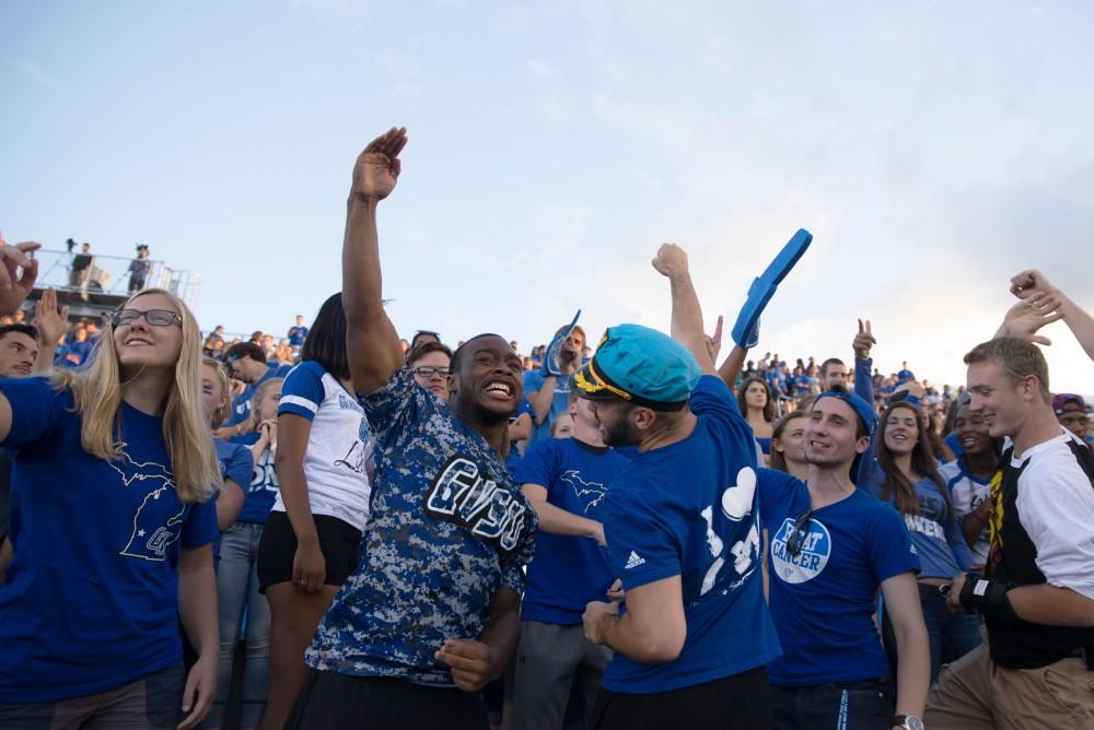 GVL / Luke Holmes - Laker fans celebrate the touchdown in the student section. Grand Valley State University defeated Tiffin 45-7 on Thursday, Sep. 1, 2016.