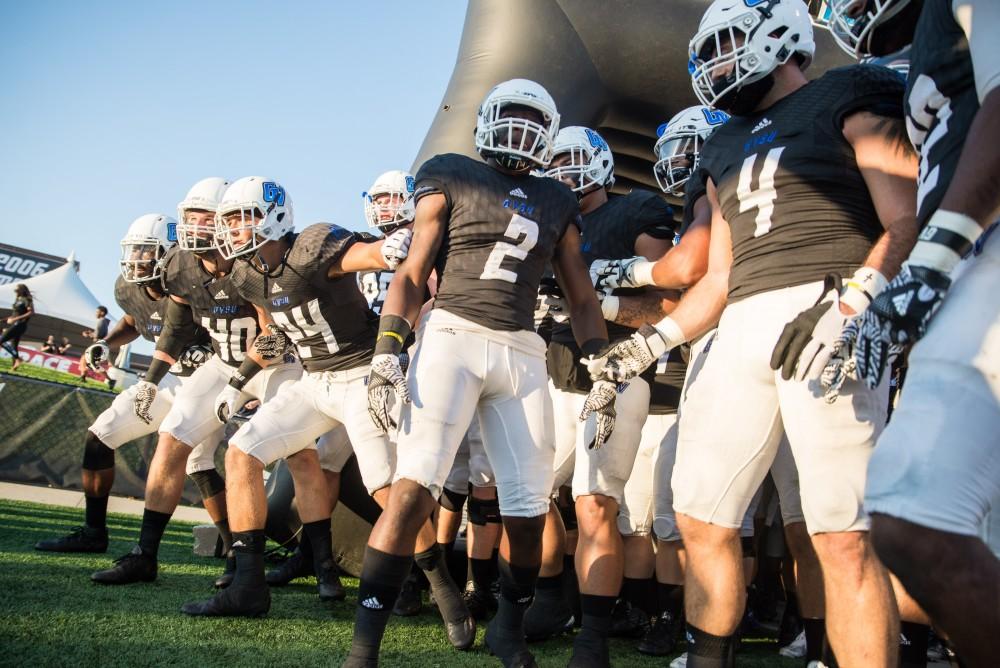 GVL / Luke Holmes - The team breaks through the tunnel at the start of the game. The Lakers defeated Northern in Lubber's Stadium Saturday, Sept. 17, 2016.