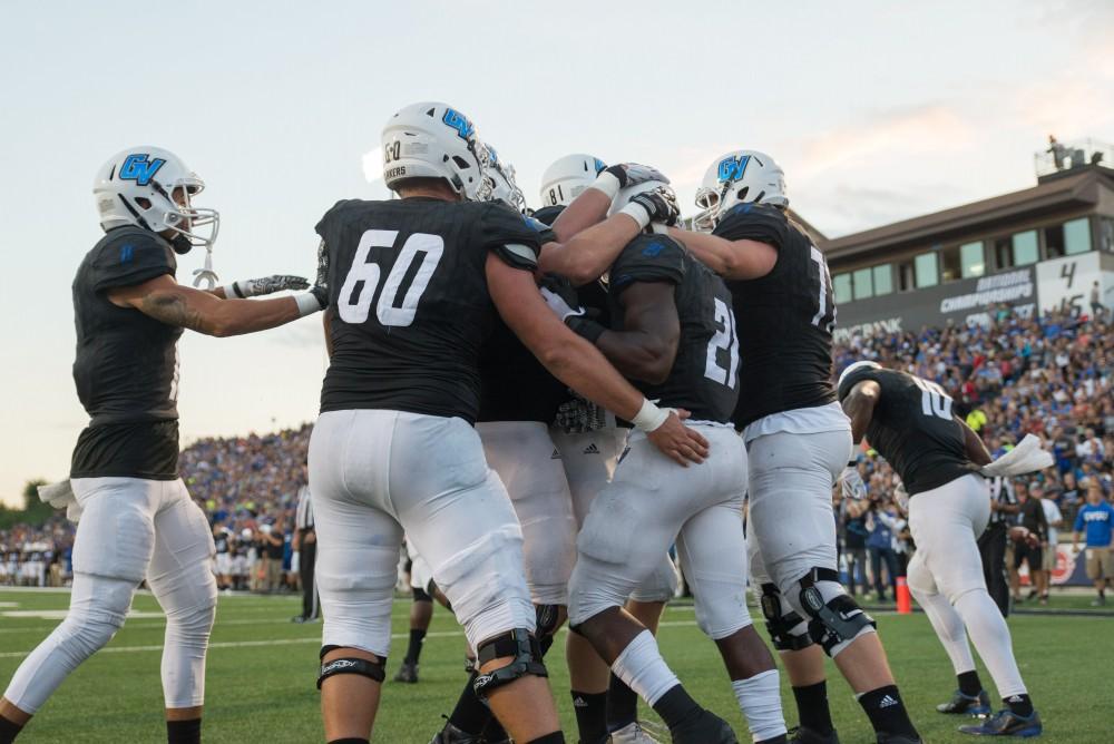 GVL / Luke Holmes - The team celebrates by lifting Marty Carter (21) up in the air after he scores a touchdown. GVSU defeated Lake Erie College 55-7 on Saturday, Sep. 10, 2016.