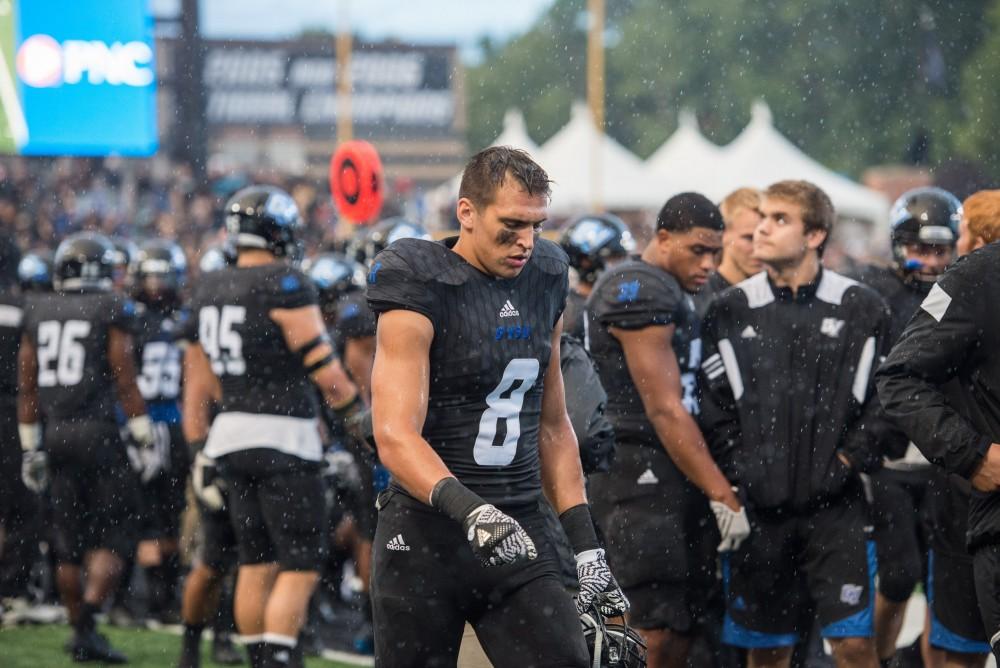 GVL / Luke Holmes - Joe Robbins (8) walks through the rain during the first half. GVSU defeated Lake Erie College 55-7 on Saturday, Sep. 10, 2016.