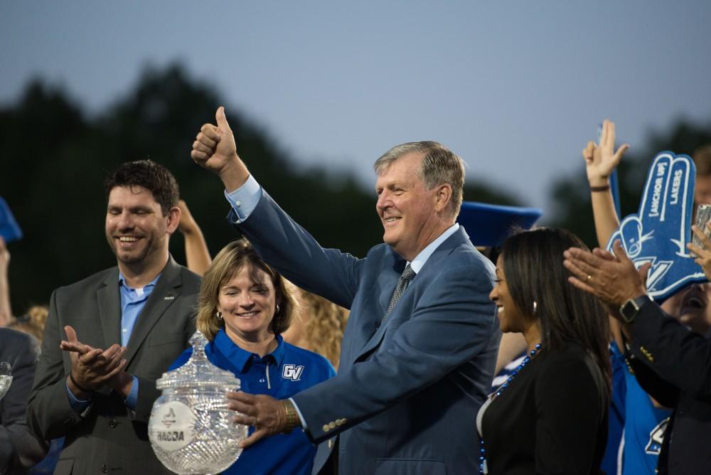 GVL / Luke Holmes - President Thomas Haas touches the Director’s Cup. Grand Valley State University defeated Tiffin 45-7 on Thursday, Sep. 1, 2016.