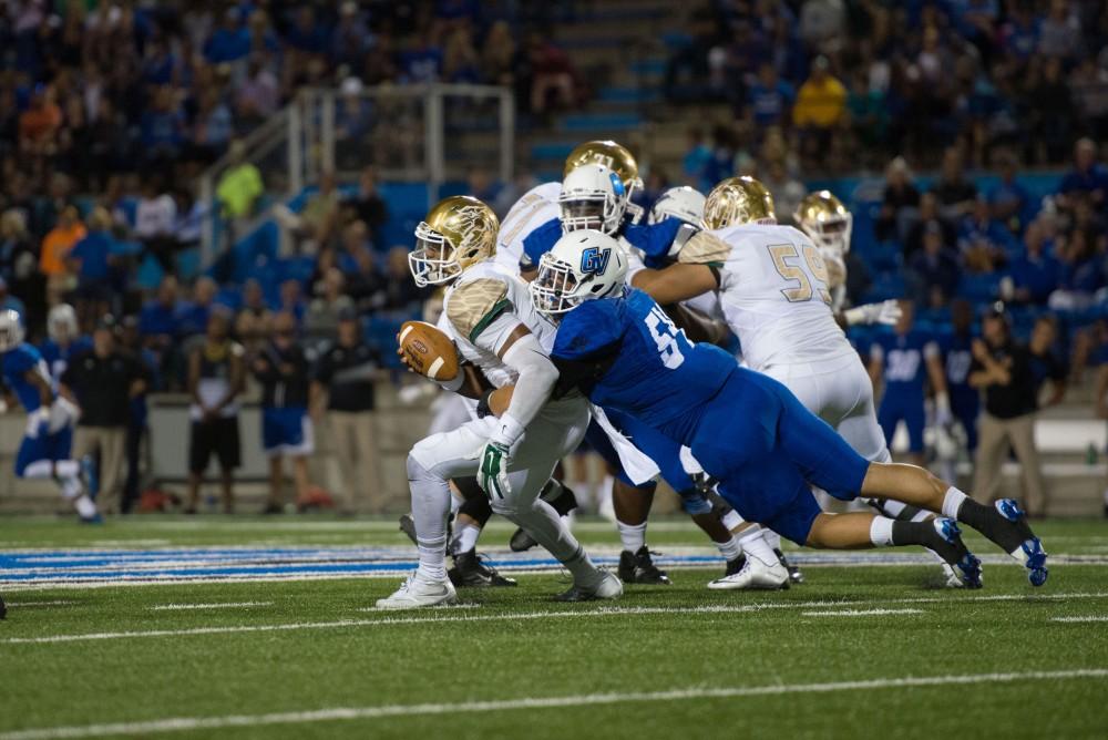 GVL / Luke Holmes - Dylan Carroll (54) sacks the opposing team’s quarterback. Grand Valley State University defeated Tiffin 45-7 on Thursday, Sep. 1, 2016.