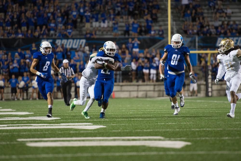 GVL / Luke Holmes - Terrell Dorsey (22) stays standing while his opponent tries to tackle him. Grand Valley State University defeated Tiffin 45-7 on Thursday, Sep. 1, 2016.