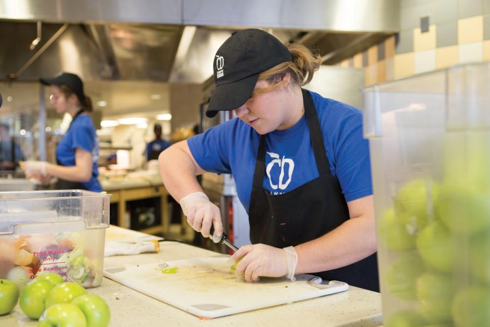 GVL / Sara Carte - Campus dining worker, Nicole Buchmann, cores apples in Fresh on Monday, Mar. 28, 2016.