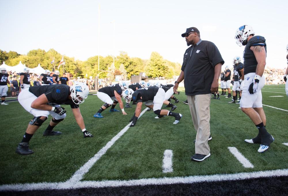 GVL/Kevin Sielaff - Defensive line coach E.J. Whitlow warms up Grand Valley's defense before the match. The Lakers defeat the Wildcats of Northern Michigan with a final score of 50-24 on Saturday, Sept. 17, 2016 in Allendale.