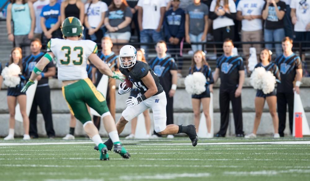 GVL/Kevin Sielaff - Matt Williams (24) receives a kick-off punt and carries the ball up field. The Lakers defeat the Wildcats of Northern Michigan with a final score of 50-24 on Saturday, Sept. 17, 2016 in Allendale.