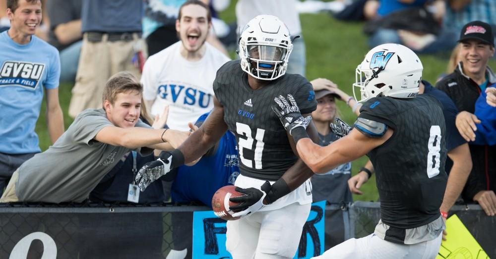 GVL/Kevin Sielaff - Marty Carter (21) celebrates a touchdown run. The Lakers defeat the Wildcats of Northern Michigan with a final score of 50-24 on Saturday, Sept. 17, 2016 in Allendale.