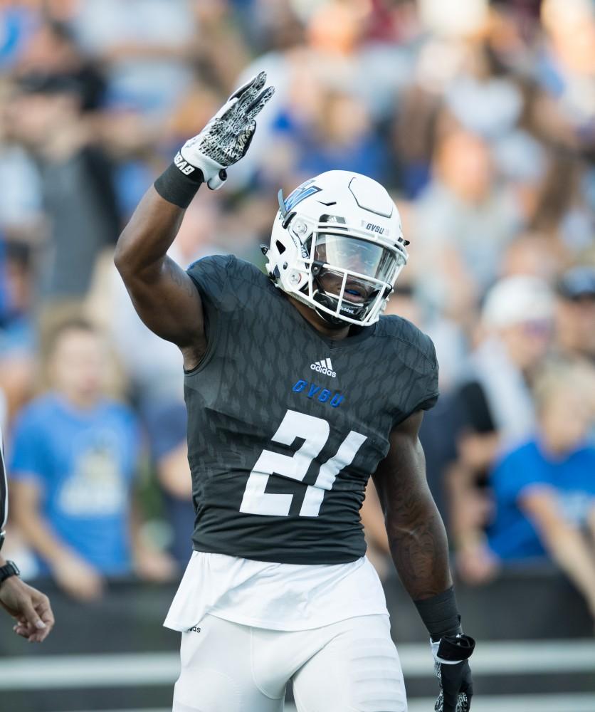 GVL/Kevin Sielaff - Marty Carter (21) celebrates a touchdown run. The Lakers defeat the Wildcats of Northern Michigan with a final score of 50-24 on Saturday, Sept. 17, 2016 in Allendale.