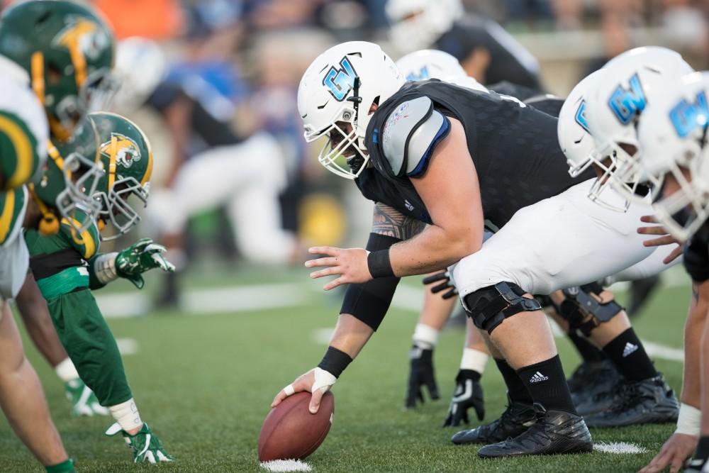 GVL/Kevin Sielaff - Aaron Cox (51) sets himself up on the line of scrimmage. The Lakers defeat the Wildcats of Northern Michigan with a final score of 50-24 on Saturday, Sept. 17, 2016 in Allendale.