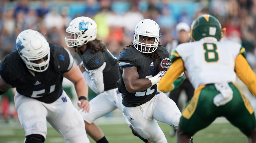 GVL/Kevin Sielaff - Terrell Dorsey (22) receives a hand-off and heads toward the end zone. The Lakers defeat the Wildcats of Northern Michigan with a final score of 50-24 on Saturday, Sept. 17, 2016 in Allendale.