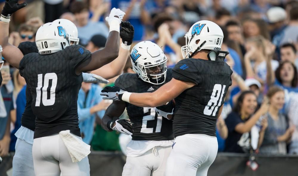 GVL/Kevin Sielaff - Marty Carter (21) celebrates a touchdown run. The Lakers defeat the Wildcats of Northern Michigan with a final score of 50-24 on Saturday, Sept. 17, 2016 in Allendale.