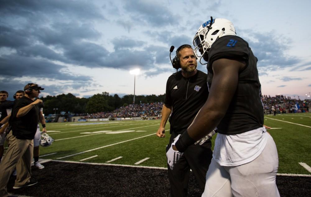 GVL/Kevin Sielaff - Head coach Matt Mitchell has a word with Marty Carter (21) after a touchdown run. The Lakers defeat the Wildcats of Northern Michigan with a final score of 50-24 on Saturday, Sept. 17, 2016 in Allendale.