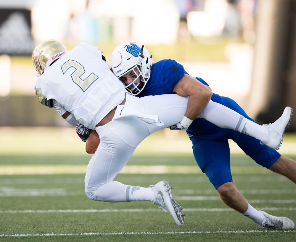 GVL/Kevin Sielaff - Garrett Pougnet tackles opposing QB Antonio Pipkin (2). Grand Valley defeats Tiffin with a final score of 45-7 on Thursday, September 1, 2016 at Lubbers Stadium.