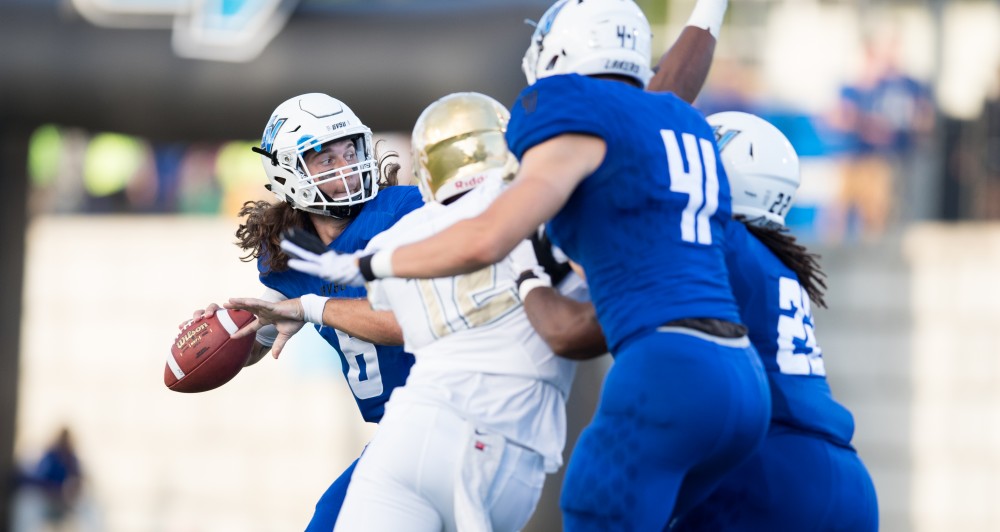 GVL/Kevin Sielaff - Bart Williams (6), under pressure, launches a pass down field. Grand Valley defeats Tiffin with a final score of 45-7 on Thursday, September 1, 2016 at Lubbers Stadium.