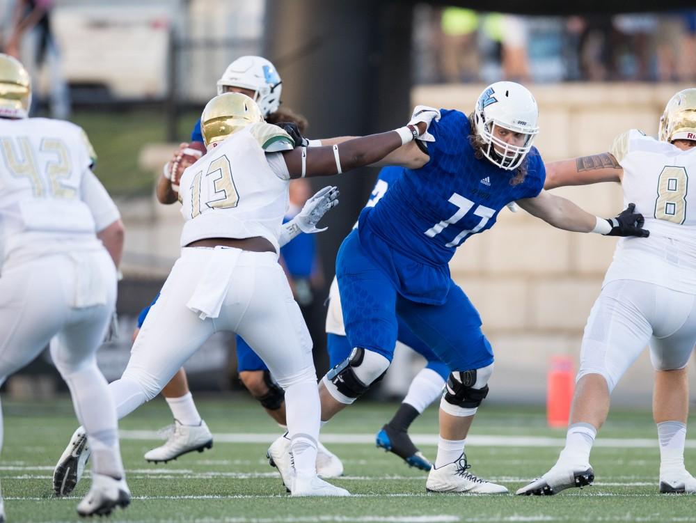 GVL/Kevin Sielaff - Nick Fish (77) blocks for Bart Williams (6). Grand Valley defeats Tiffin with a final score of 45-7 on Thursday, September 1, 2016 at Lubbers Stadium.