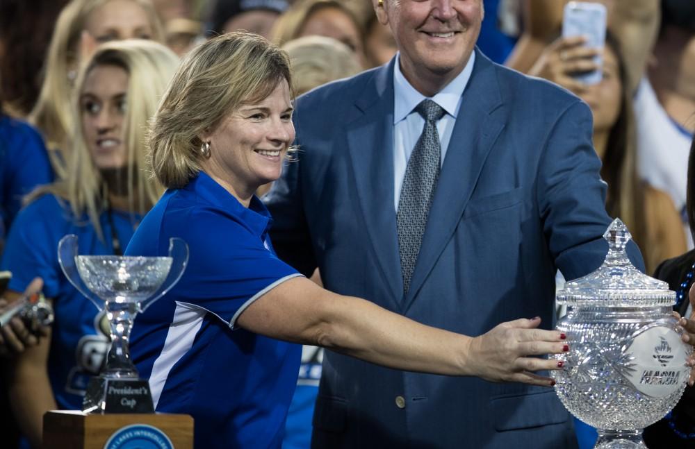 GVL/Kevin Sielaff - GVSU Athletic Director Keri Becker stands with the Director's cup alongside GVSU President Thomas Haas. Grand Valley defeats Tiffin with a final score of 45-7 on Thursday, September 1, 2016 at Lubbers Stadium.