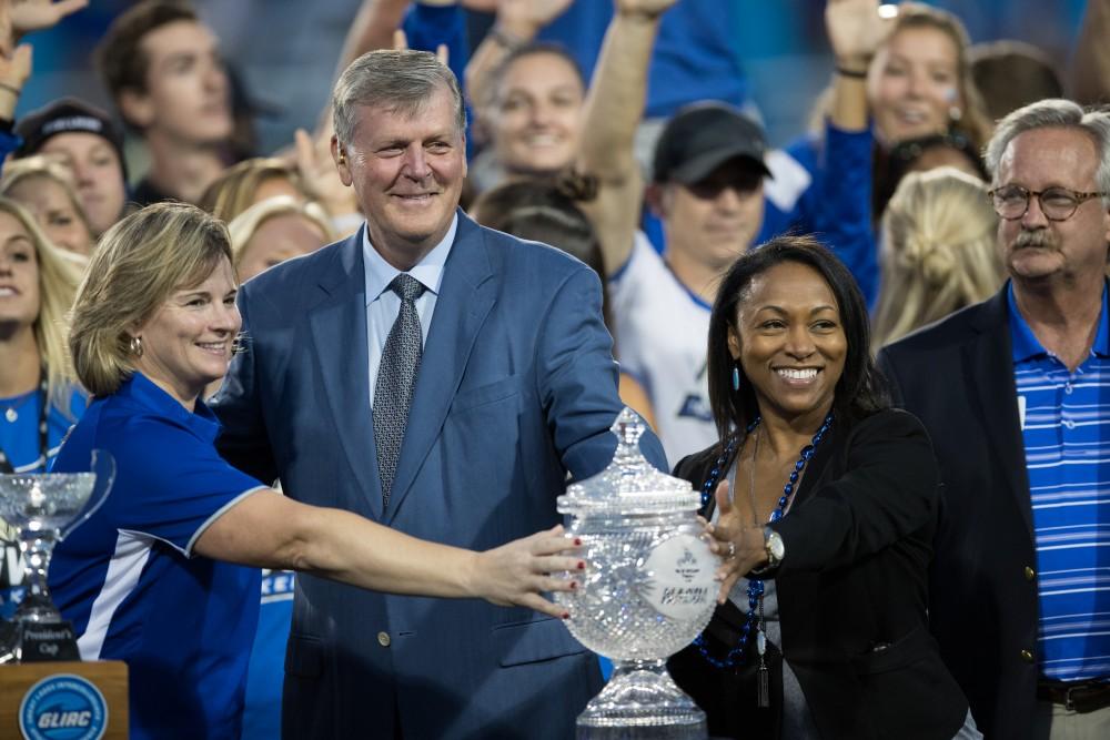 GVL/Kevin Sielaff - GVSU President Thomas Haas stands with the Director's cup. Grand Valley defeats Tiffin with a final score of 45-7 on Thursday, September 1, 2016 at Lubbers Stadium.