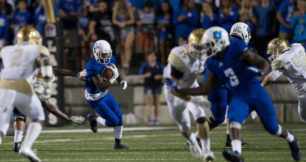 GVL/Kevin Sielaff - Christian Lumpkin (23) receives a hand-off and moves the ball up field. Grand Valley defeats Tiffin with a final score of 45-7 on Thursday, September 1, 2016 at Lubbers Stadium.