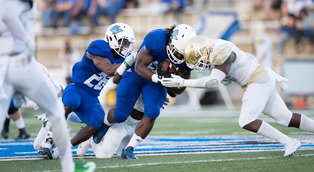 GVL/Kevin Sielaff - Terrell Dorsey (22) lowers his shoulder as he charges down field. Grand Valley defeats Tiffin with a final score of 45-7 on Thursday, September 1, 2016 at Lubbers Stadium.