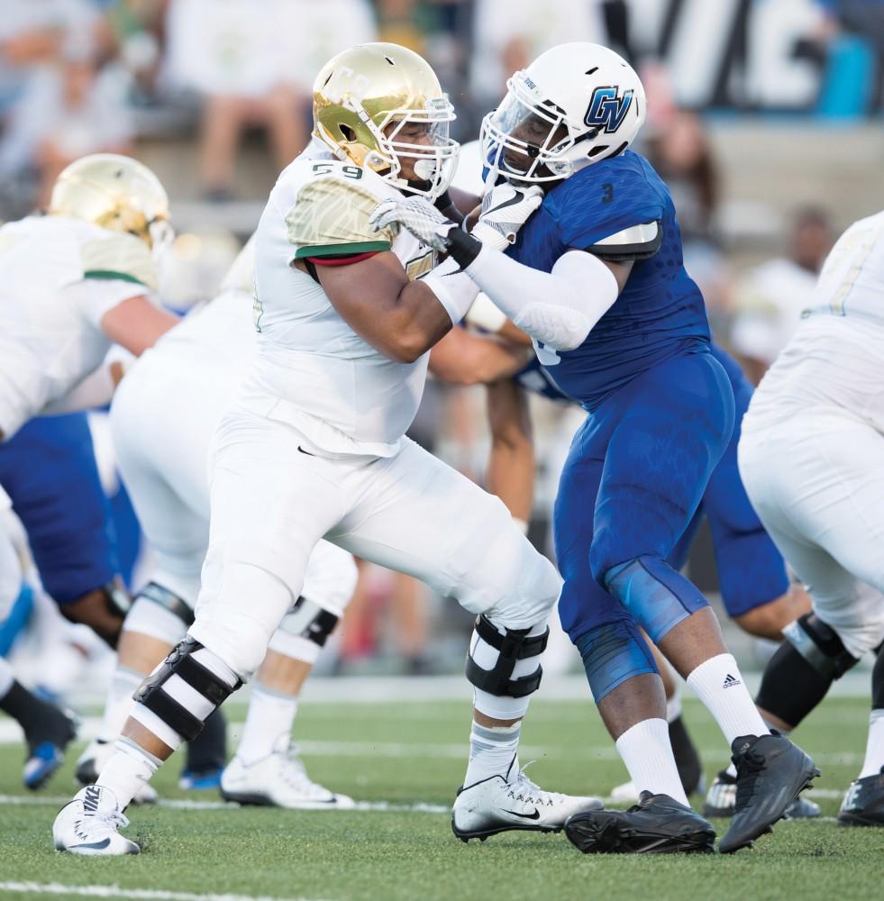 GVL/Kevin Sielaff - Sydney Omameh (3) spars with Tiffin's Azell Mitchell (59). Grand Valley defeats Tiffin with a final score of 45-7 on Thursday, September 1, 2016 at Lubbers Stadium.