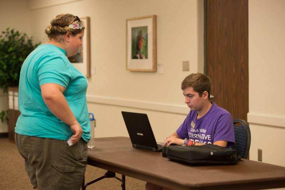 GVL / Luke Holmes -  Andrew Carter helps a student get registered during Ignite in the Grand River Room on Tuesday, Sep. 6, 2016.