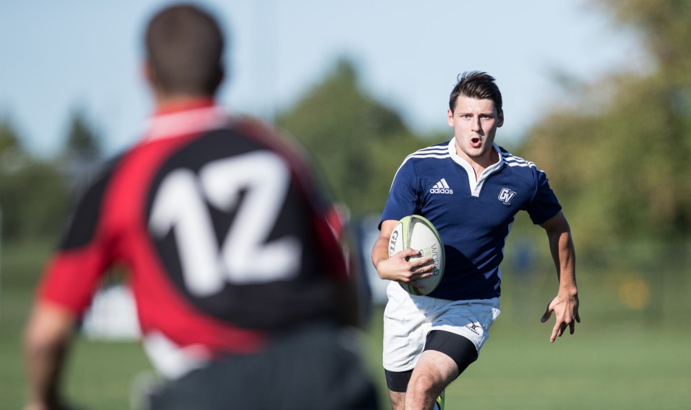 GVL/Kevin Sielaff - Andrew Novak (10) moves the ball up field and scores. GVSU men's club rugby defeats rival SVSU by a large margin Saturday, Sept. 24, 2016. 