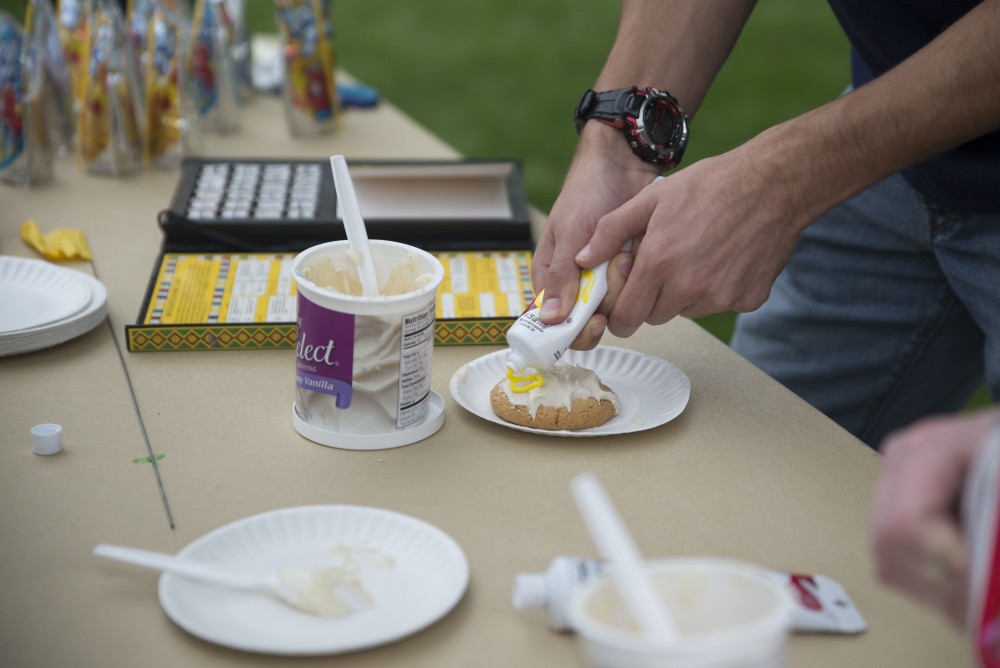 GVL / Luke Holmes - A student decorates a cookie. The Paleo-Olympics were held in the KC West Lawn on Friday, Sept. 23, 2016.