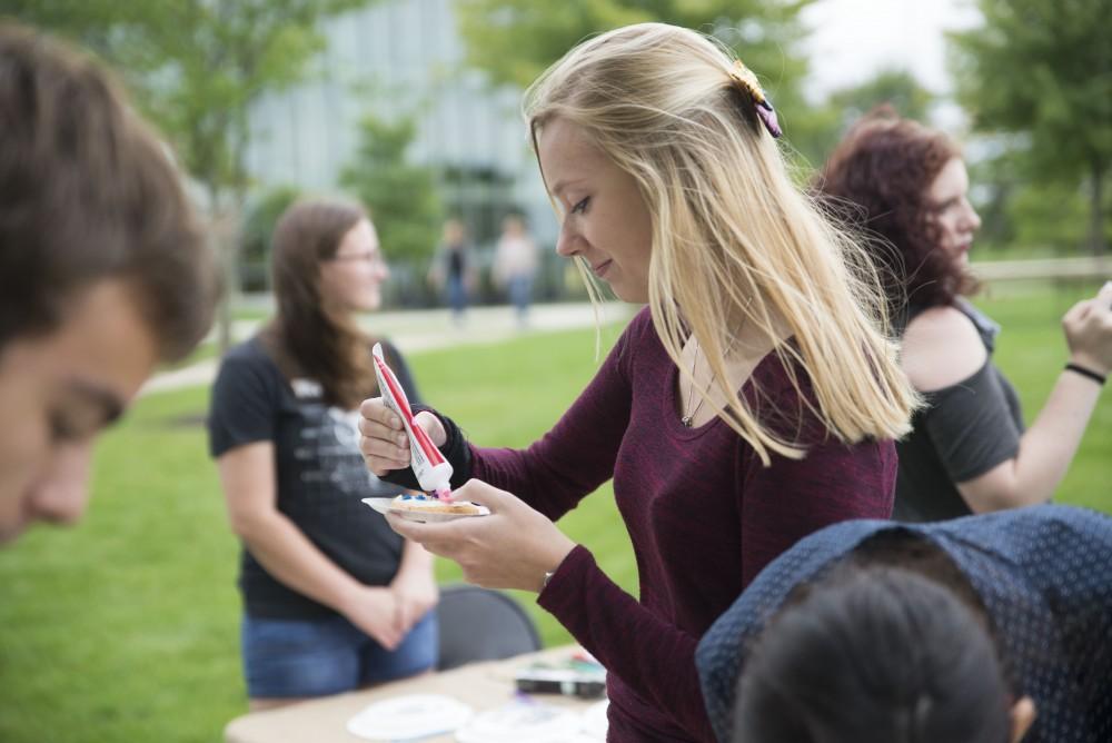 GVL / Luke Holmes - Ariana Martineau decorates a cookie. The Paleo-Olympics were held in the KC West Lawn on Friday, Sept. 23, 2016.