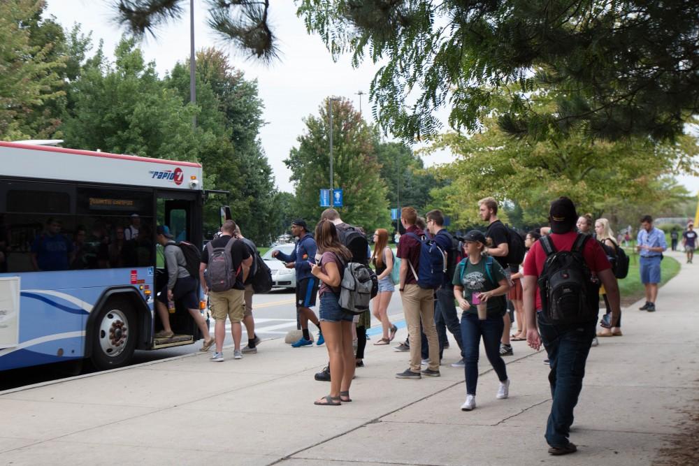 GVL/Mackenzie Bush - Students gather at various Rapid bus stops Thursday, Sept. 22, 2016.