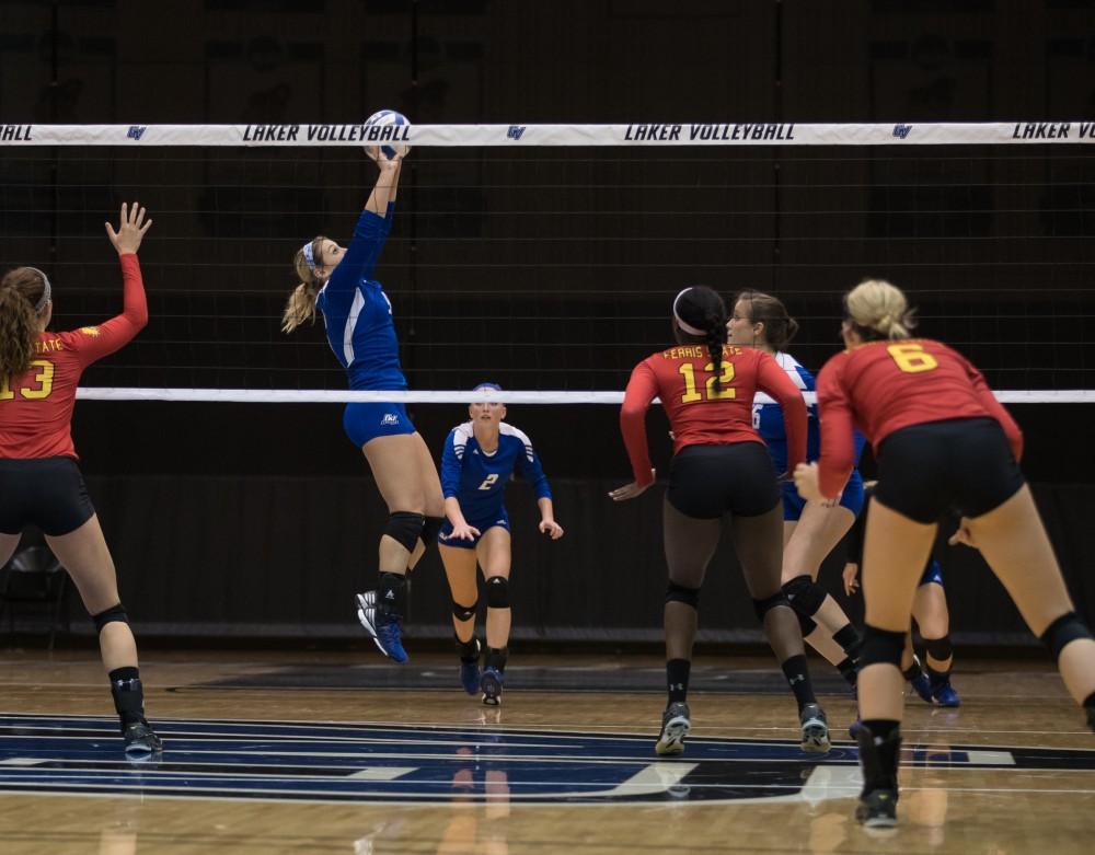 GVL/Kevin Sielaff - Katie Olson (9) sets the ball. The Lakers fall to the Bulldogs of Ferris State with a final score of 1-3 Tuesday, Sept. 27, 2016 in Allendale.