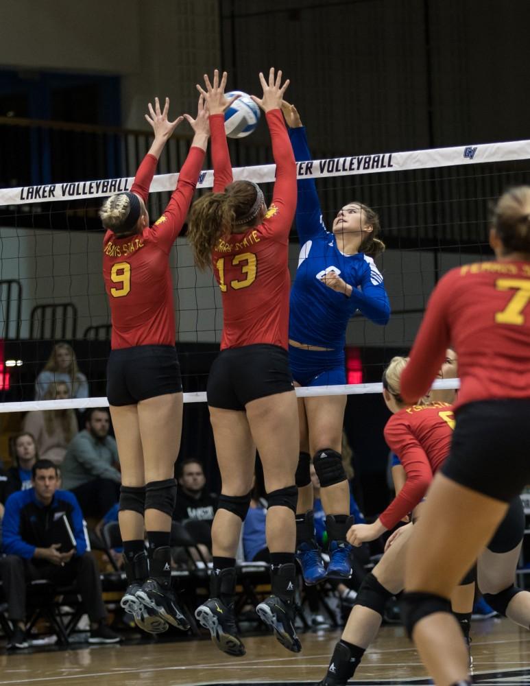 GVL/Kevin Sielaff - Brooke Smith (8) meets a host of Bulldogs as she tries to send the ball over the net. The Lakers fall to the Bulldogs of Ferris State with a final score of 1-3 Tuesday, Sept. 27, 2016 in Allendale.