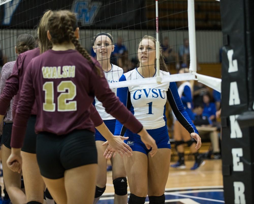 GVL/Kevin Sielaff - Sydney Benchley (1) shakes hands with players from Walsh before the match. The Lakers sweep the Cavaliers of Walsh University Saturday, Sept. 24, 2016 in Allendale.