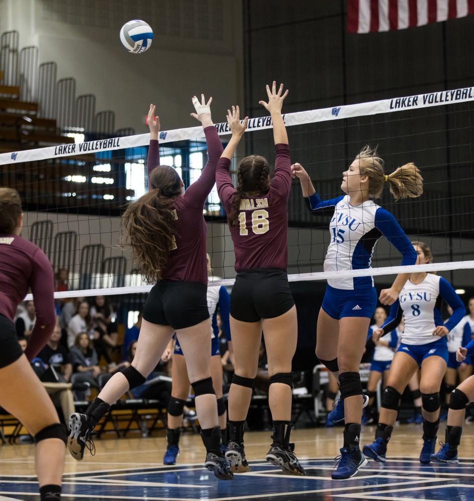 GVL/Kevin Sielaff - Jayci Suseland (15) spikes the ball into traffic. The Lakers sweep the Cavaliers of Walsh University Saturday, Sept. 24, 2016 in Allendale.