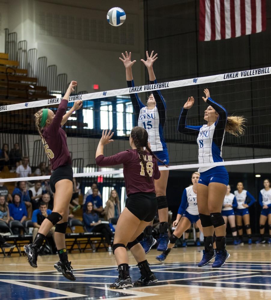 GVL/Kevin Sielaff - Jayci Suseland (15) and Brooke Smith (8) rise up to try and block a spike. The Lakers sweep the Cavaliers of Walsh University Saturday, Sept. 24, 2016 in Allendale.